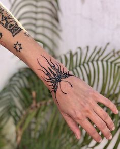 a person's arm with a tattoo on it and a spider crawling out of it