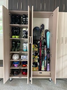 two wooden cabinets with skis and snowboards on them in a room that has carpeted flooring