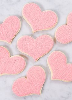 Buttercream Sugar Cookie Hearts | These sugar cookies aren’t only easy to make, they’re delicious. Once you’ve mastered the dough and baking, then comes the fun part: decorating. I like to use soft icing colors, like this pink you see below made with McCormick red food color for a perfect valentine's day cookies! || JennyCookies.com and @mccormickspices