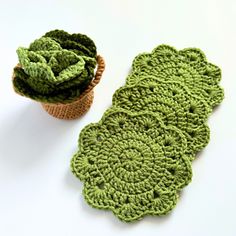 green crocheted coasters sitting next to each other