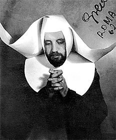 a black and white photo of a man wearing a nun costume