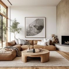 a living room with a couch, coffee table and large window overlooking the outdoors area