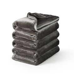 a stack of towels sitting on top of each other in front of a white background