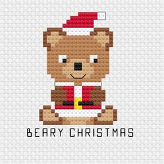 a cross stitch christmas card with a teddy bear wearing a santa hat