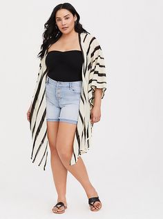 A striped ruana gives you an instant boho look, while lightweight fabric keeps you feeling (and looking) cool all summer long. Open front. Side self-tie; vented. 3/4 sleeves. CONTENT + CARE: Acrylic. Hand wash; dry flat. Imported plus size kimono. SIZE + FIT: Model is 5'10”. This item is One Size and measures 37. 25” from shoulder . The best plus size women's ivory & black stripe ruana capes ponchos ruanas in ivory. Torrid is your destination for cozy fall and winter clothes to keep you warm and Chiffon Kimono, Plus Size Coats, Boho Look, Winter Clothes, Black Laces, Fashion Studio, Cozy Fall, Plus Size Tops