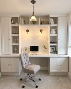 a chair sitting in front of a desk with a computer on it and shelves above