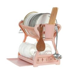 a pink dish rack with plates and utensils