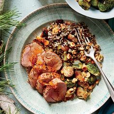 a plate with meat and vegetables on it next to a bowl of broccoli