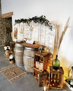 a room filled with lots of wooden barrels next to a wall covered in greenery