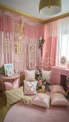 a room with pink and gold decor on the walls, windows, and bedding