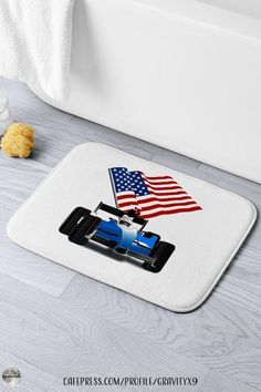 a blue race car with an american flag on the front is shown in this bathroom rug