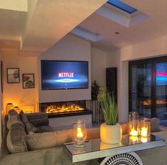 a living room filled with furniture and a flat screen tv mounted to the side of a wall