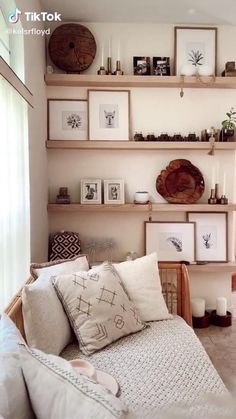 a living room filled with lots of furniture and pictures on the wall above it's shelves