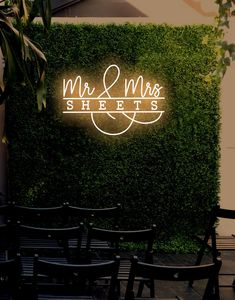 the neon sign for mr and mrs sheets is lit up in front of some chairs