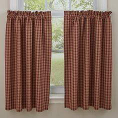 a red and white checkered curtain hanging on the side of a window sill