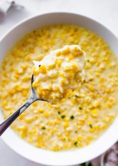 a spoon full of corn and cheese soup