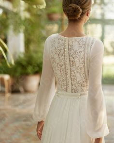 the back of a woman's white wedding dress