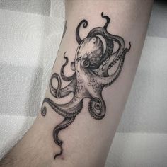 an octopus tattoo on the arm