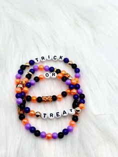 👻 Set of 3 Personalized Halloween Beaded Bracelets Customize Halloween Beaded Bracelet Spooky Jewelry for Halloween Costume Jewelry Name Bracelet Halloween Party Favor ✋Handmade Bracelets Made with colorful plastic beads in typical Halloween Colors. 🎃Sold as a set of 3 📏 Bracelets are between 7 inches and 7.5 inches 🎃How to Care for Bracelet:   ❤Remove bracelets to shower, sweat, swim, or sleep. ❤Be careful when putting bracelets on and be sure to gently roll over your hand and wrist.  ❤They are delicate and the string could break if pulled on roughly. ❤Lotions and Perfumes are harmful to any jewelry, so keep jewelry away from you when applying lotions or perfumes ️Personlization with a maximum of 12 letters.  ⚠️Please note: These are not intended for babies or children. Small parts co Halloween Beaded Bracelets With Letter Beads, Halloween Bracelets With Letter Beads And Round Shape, Halloween Letter Beads Bracelet With Round Beads, Halloween Jewelry With Round Letter Beads, Halloween Beaded Bracelets For Party, Halloween Multicolor Beaded Bracelets, Spooky Jewelry, Halloween Costume Jewelry, Jewelry Name