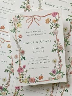 wedding stationery with flowers and ribbons on the front, back and side of the stationery