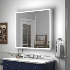 a bathroom with a sink, mirror and towel rack