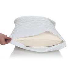 a person is holding a pillow on top of it