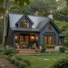 a house that is surrounded by trees and grass