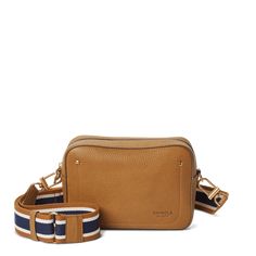 The Camera Bag is a day bag designed with 35mm sensibilities. Slip your phone, keys, and wallet in for the weekday—and a few extra rolls for your next shoot. | Shinola Women's Camera Crossbody Bag in Tan Natural Grain Leather Leather Travel Bag Strap With Mobile Phone Bag, Leather Bag Strap With Mobile Phone Bag For Travel, Crossbody Bag Strap With Removable Pouch For Travel, Leather Conditioner, Natural Tan, Day Bag, Leather Care, Leather Items, Small Leather Goods