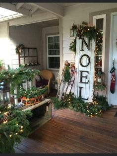 a porch decorated for christmas with wreaths and lights