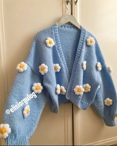 a blue sweater with white flowers on it