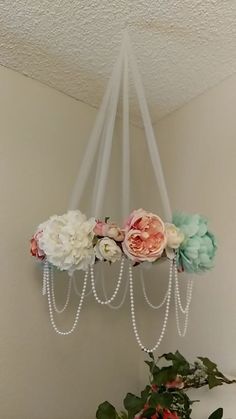 a chandelier with flowers hanging from it