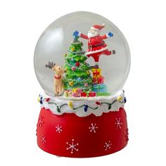 a snow globe with a christmas tree and santa clause in it on top of a red base