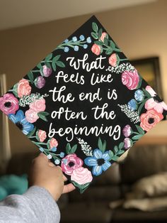 someone is holding up a graduation cap that says, what feels like the end is often the beginning