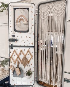 the inside of a white trailer with decorative items on it's door and window