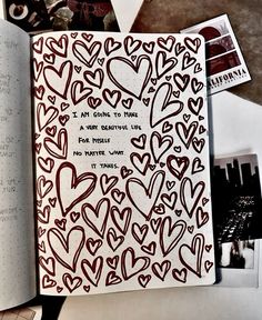 an open notebook with lots of hearts on it