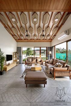 a living room with couches, chairs and tables in it's center area