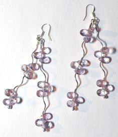 Whether night or day, these delicate Amethyst earrings will be sure to dangle the sorrow away.  The light just dances on these stones and you are sure to turn heads when wearing them.    Stones - Amethyst Finding\/components - Sterling silver  STONE COLOR - Pictures were lighted to show detail. See last picture for actual stone color.  NOTE: Slight variations in the piece you will receive from the one pictured are to be expected due to the hand made nature of the item.   Photos by Evan Spring  A Lavender Amethyst Teardrop Earrings, Lavender Amethyst Gemstone Earrings, Handmade Lavender Crystal Drop Earrings, Amethyst Natural Stone Dangle Earrings, Amethyst Wire Wrapped Drop Earrings, Amethyst Gemstone Dangle Earrings, Amethyst Dangle Earrings For Jewelry Making, Handmade Amethyst Crystal Earrings, Amethyst Dangle Earrings With Natural Stones