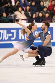 a man and woman skating on an ice rink