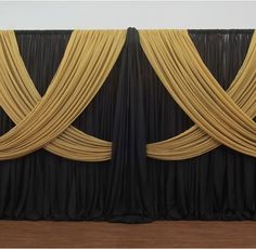 two black and yellow drapes are hanging on the wall