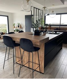 a kitchen island with two bar stools next to it