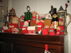 a group of christmas figurines sitting on top of a dresser