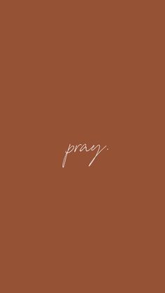 the word pray written in white ink on a brown background