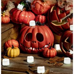 halloween pumpkins and candles on a wooden table