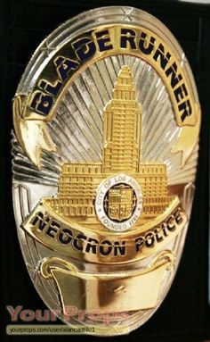 a police badge is shown on a black box with gold lettering and a clock tower in the background