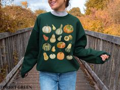 Embrace the cozy vibes of autumn with our Pumpkin Patch Sweatshirt, perfect for any fall occasion! This women's fall sweatshirt features a beautiful collage of watercolor pumpkins and gourds, capturing the essence of the season in every detail. Whether you're headed to a pumpkin patch or just want to add a touch of the autumn aesthetic to your wardrobe, this crewneck is your go-to. Ideal for layering during those crisp fall days, it's also a great choice for a Thanksgiving pullover. Stay stylish Cozy Fit Green Top For Fall, Green Sweatshirt For Fall, Green Comfortable Fit Sweatshirt For Fall, Green Fall Sweatshirt, Autumn Aesthetic Vintage, Vintage Pumpkins, Pumpkins And Gourds, Patch Sweatshirt, Thanksgiving Sweatshirt