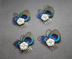 four hair combs with peacock feathers and pearls on them, sitting next to each other