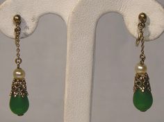 DO NOT PURCHASE. Missing from inventory.  An Art Deco gilt 830 silver filigree pair of 1-3/8" screw-back dangle earrings circa 1920s.  These vintage Danish 1 1/4" length earrings feature glass pearls, silver openwork and jade green glass drops.  They are stamped 830S and CA. We believe these earrings were designed by C.F. Andreasen (Copenhagen 1893 - 1937). Our thanks to the www.925-1000 site for the reference information.  They weigh 2.0 grams, and they are in excellent condition with no chips, cracks, dents, bends, corrosion, losses, damage or repairs. Jewelry is vintage and has signs of use and patination as would be expected. Expedited parcel to the U.S. starts at $20.00 and expedited parcel within Canada starts at $15.00 (tracking and loss insurance included). Rates vary by destinatio Vintage Drop Earrings For Pierced Ears, Vintage Formal Drop Earrings, Formal Vintage Drop Earrings, Vintage Drop Earrings With Matching Set, Vintage Drop Jewelry For Formal Occasions, Vintage Drop Jewelry Set With Matching Earrings, Ornate Dangle Clip-on Earrings For Formal Occasions, Green Filigree Earrings For Formal Occasions, Green Formal Filigree Earrings