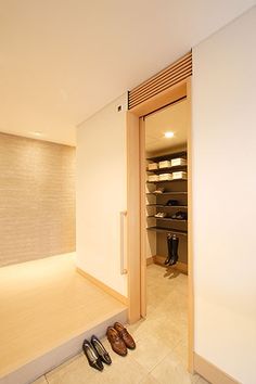 a pair of shoes sitting on the floor in front of an open closet with shelves