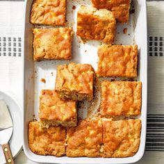 a pan filled with squares of food on top of a table