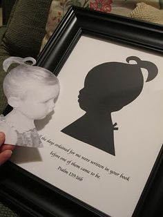 a person holding up a paper cut out of a child's head with a quote on it